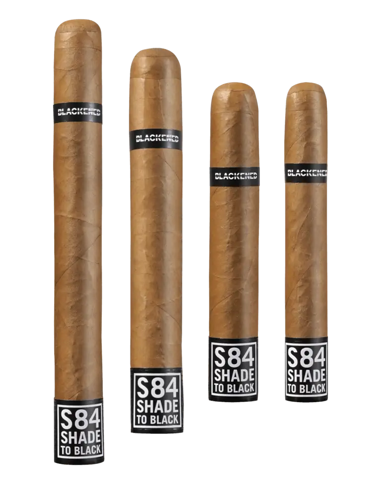 Four upright cigars from the Blackened “S84 Shade to Black” by Drew Estate line, each featuring bold branding and dark Connecticut Shade wrappers