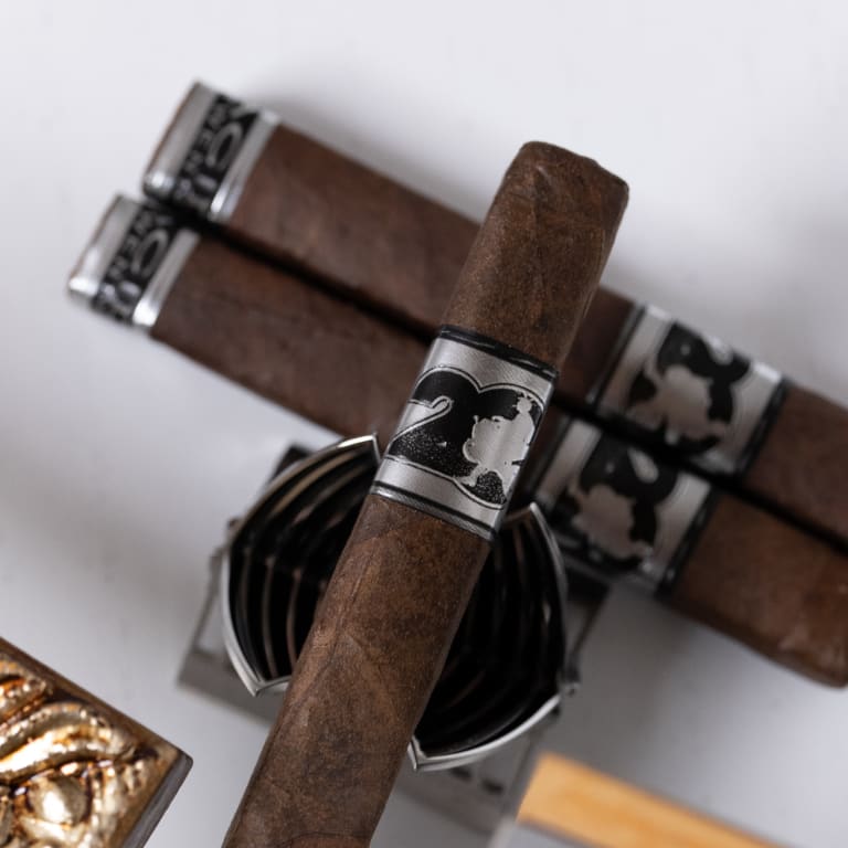 A acid 20 cigar rests atop a metal box, showcasing the Acid 20 brand's distinctive design and craftsmanship