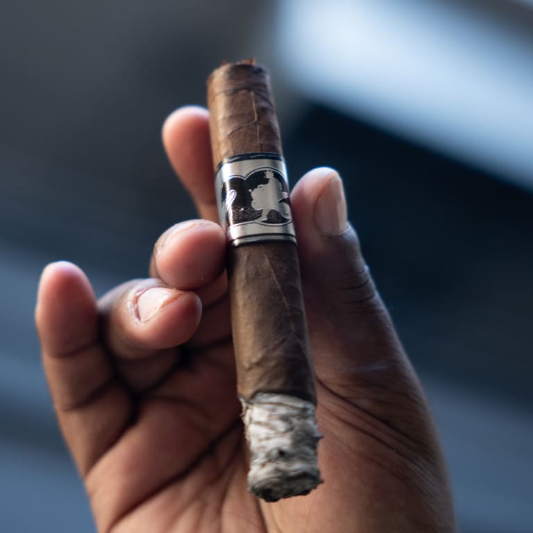 hand holding an acid 20 cigar