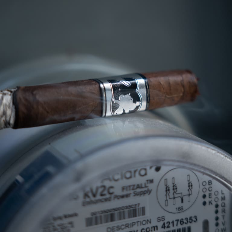 acid 20 cigar balanced on a container