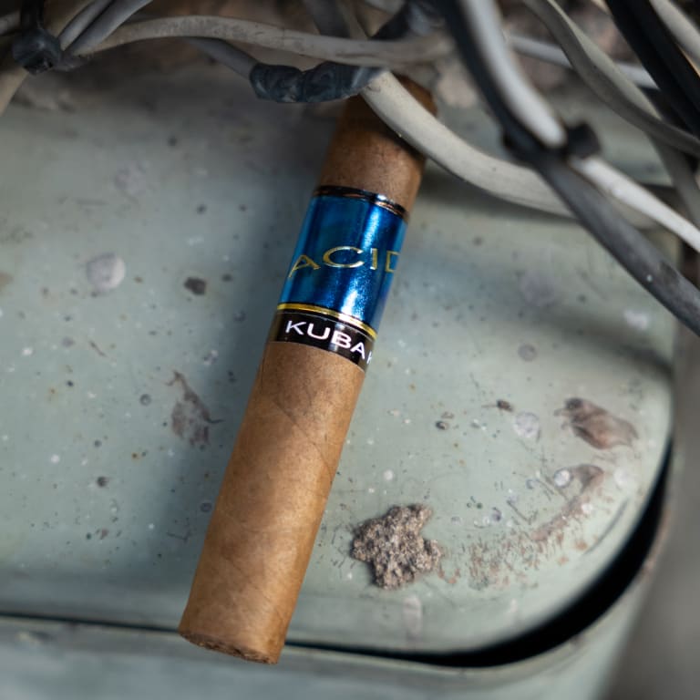 acid blue cigar on a pale blue surface