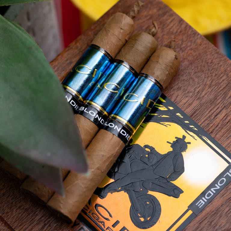 3 acid blue cigars on a wooden surface