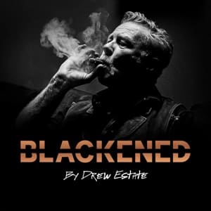 A man smoking a cigar with a text that reads Blackened by Drew Estate