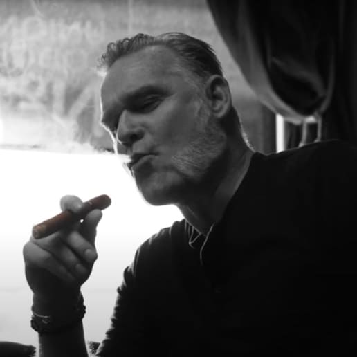 Black and white photo of a man smoking a cigar