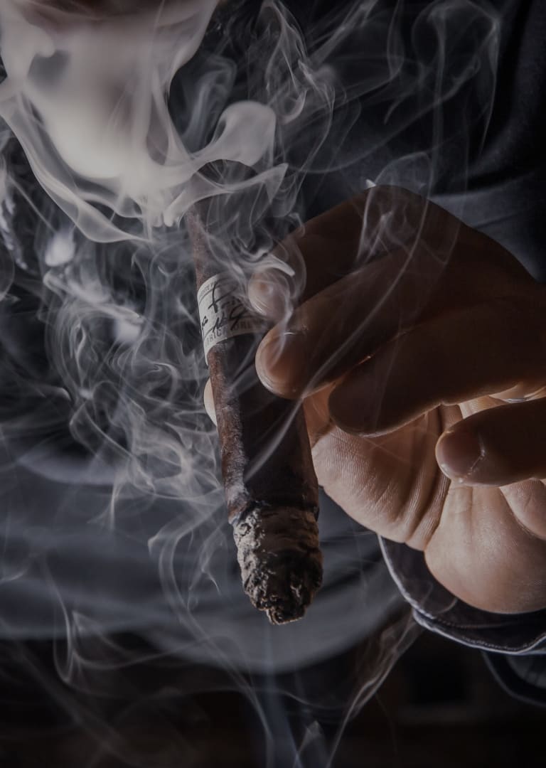 man holding smokey cigar