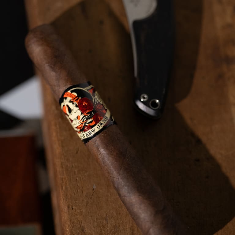 deadwood sweet jane cigar rests against a wooden surface
