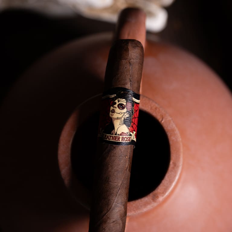 deadwood leather rose cigar laying on a clay pot