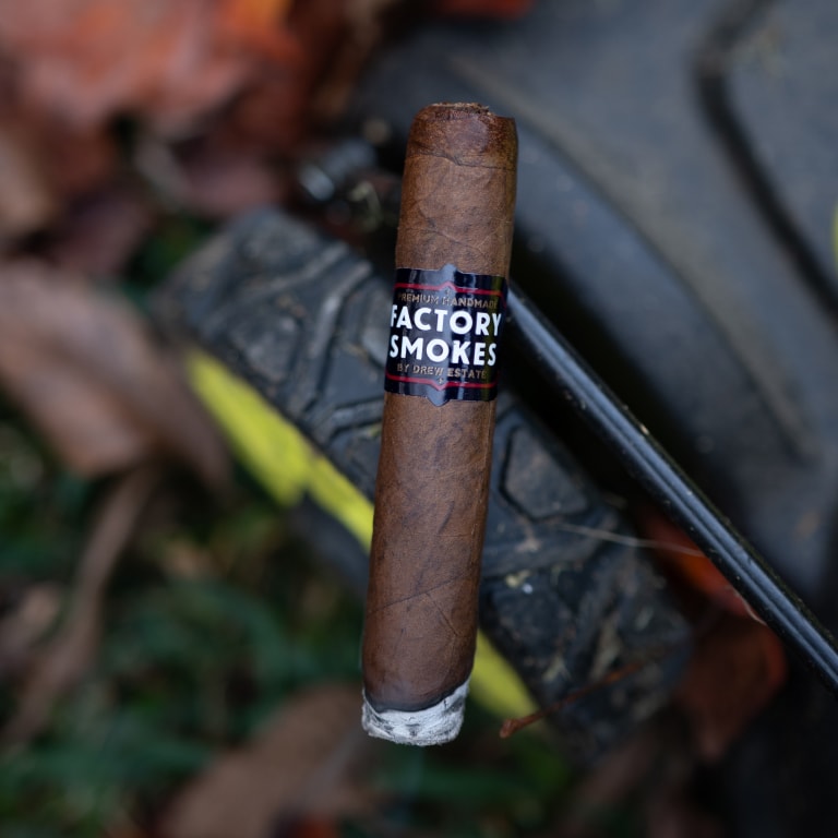 Factory Smokes Maduro cigar on a lawn mower