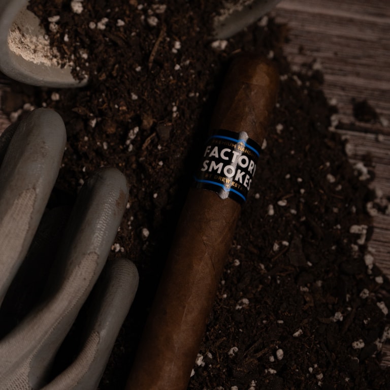 Factory Smokes Sun Grown cigar with a pot for planting plants and compost.