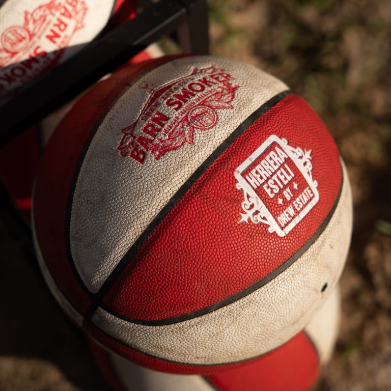 Red and white basketball featuring "Barn Smoker" and "Herrera Esteli by Drew Estate" branding