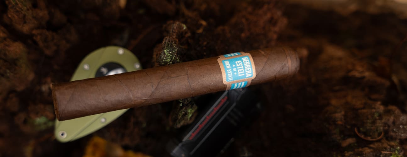 A herrera esteli cigar resting on a tree branch