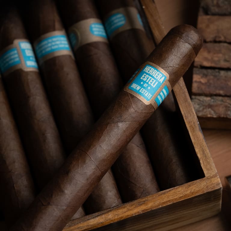 herrera esteli brazil cigar laying on a box of more cigars