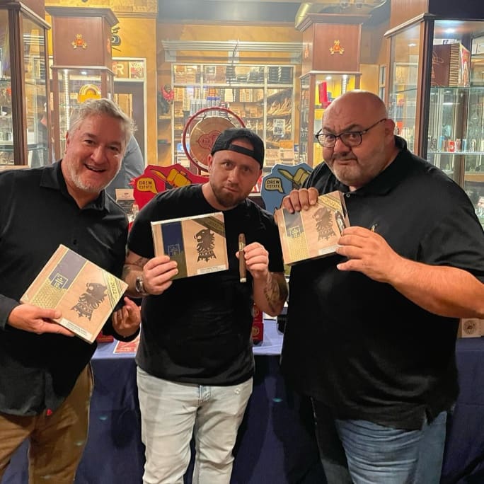 three men posing with cigar boxes