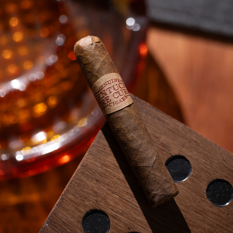 kentucky fire cured sweet cigar resting on a wooden box