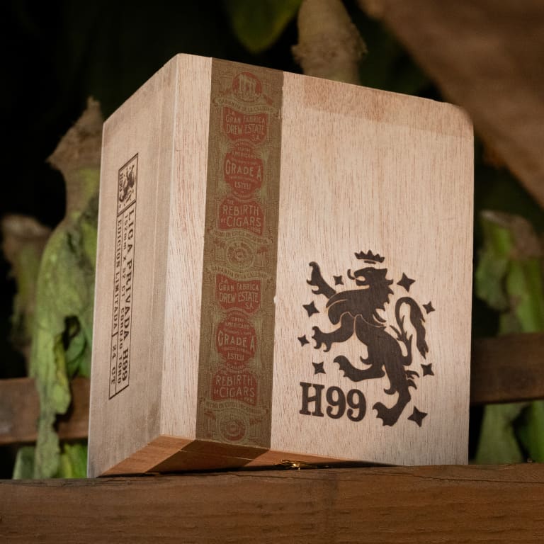 liga privada h99 cigar box resting on top of a bench