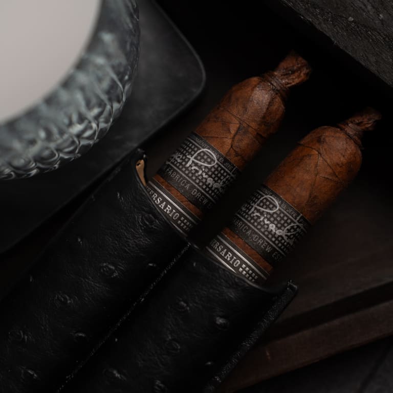2 liga privada liga 10 cigars resting in a black leather case