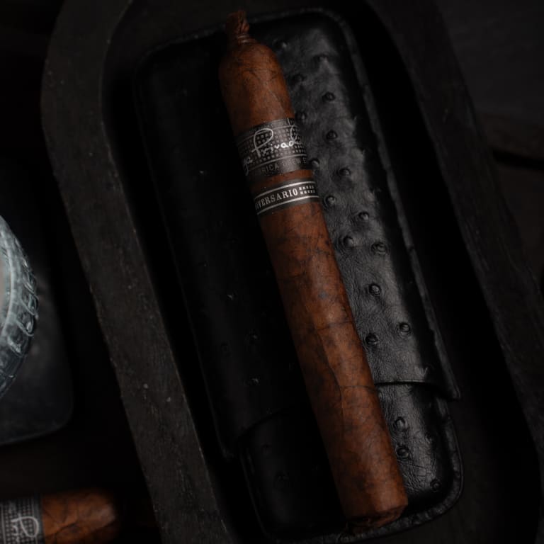 liga privada liga 10 cigar resting on a black leather case