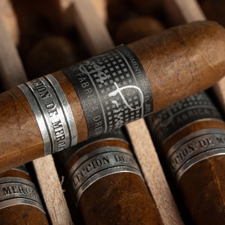 close-up of a liga privada liga 10 cigar, showcasing its intricate silver and black band