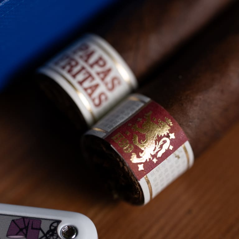 Close up of Liga privada Papas Fritas cigarson a wood surface