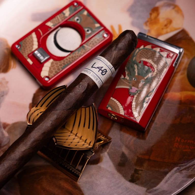 A Liga Privada Unico cigar and a lighter elegantly placed on a tray