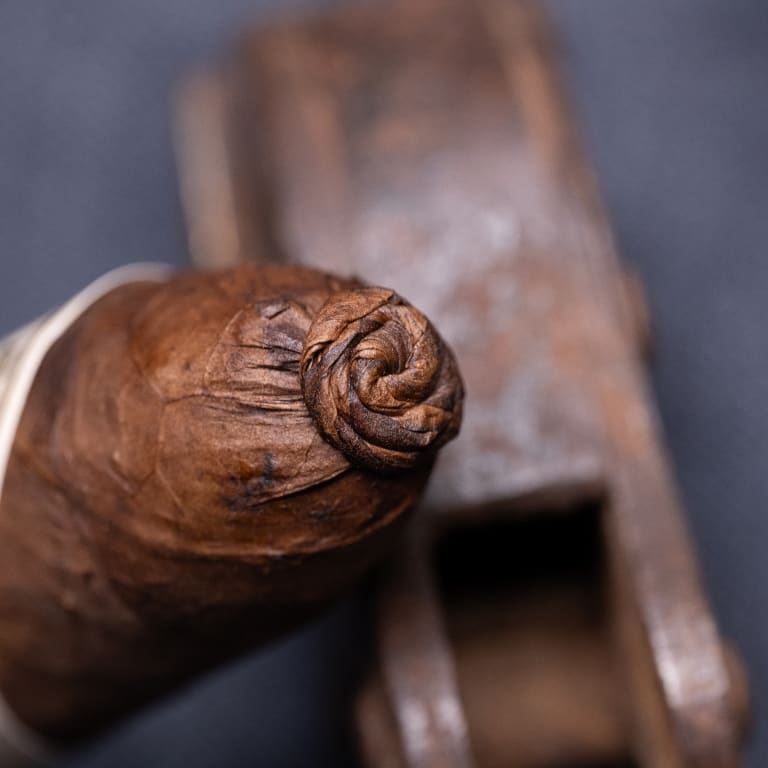 A cigar featuring a wooden handle