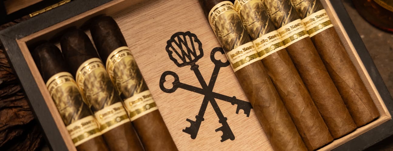 A box of cigars featuring an elegant gold cross design on the box