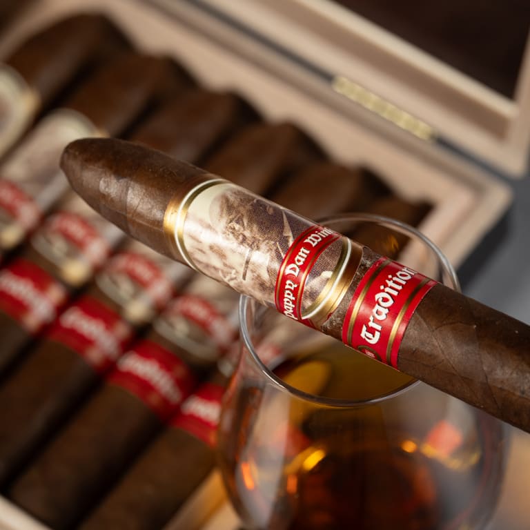 pappy van winkle traditional cigar on a glass of whiskey