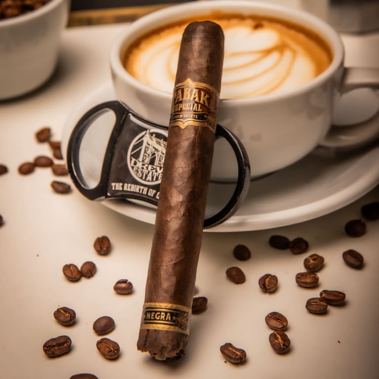 tabak especial negra cigar resting on a coffee mug