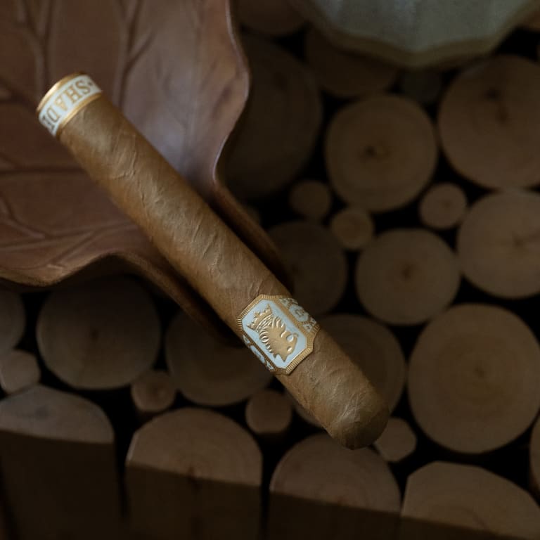 undercrown shade cigar over wood logs