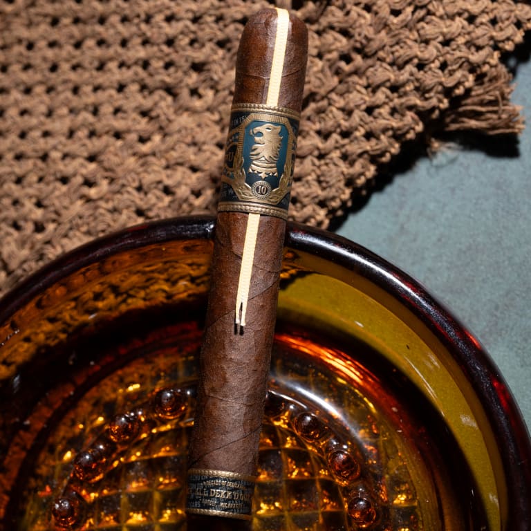 Close-up of 3 undercrown UC10 cigars over an ashtray