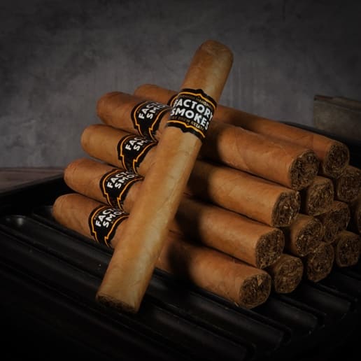 A collection of Factory Smokes Shade cigars arranged atop a wood surface