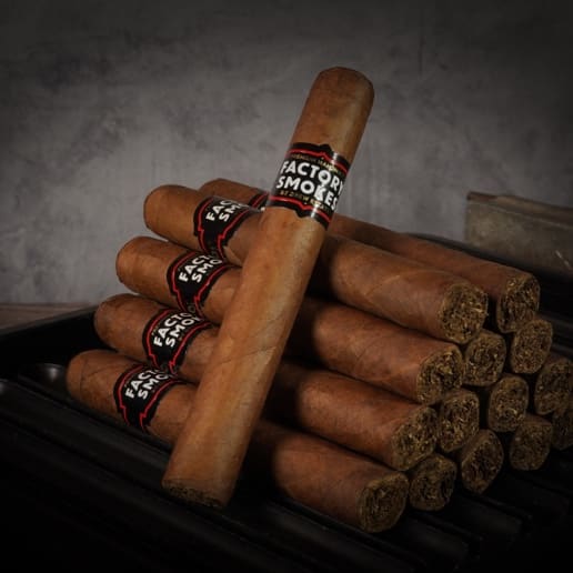 A collection of Factory Smokes Sweet cigars arranged atop a wood surface
