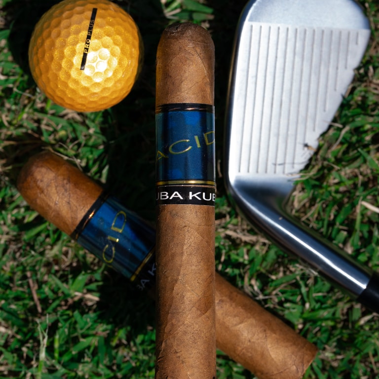 2 Acid Blue cigars with a golf club and a golf ball