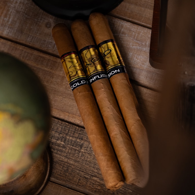 3 Acid Gold cigars on a wooden table