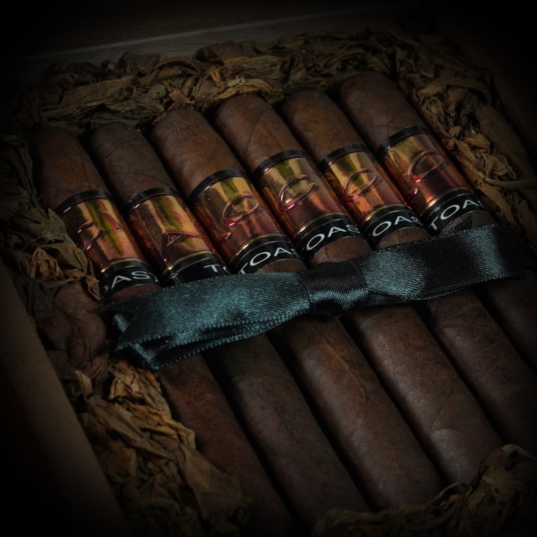 a group of 6 Acid cigars tied with a black silk ribbon