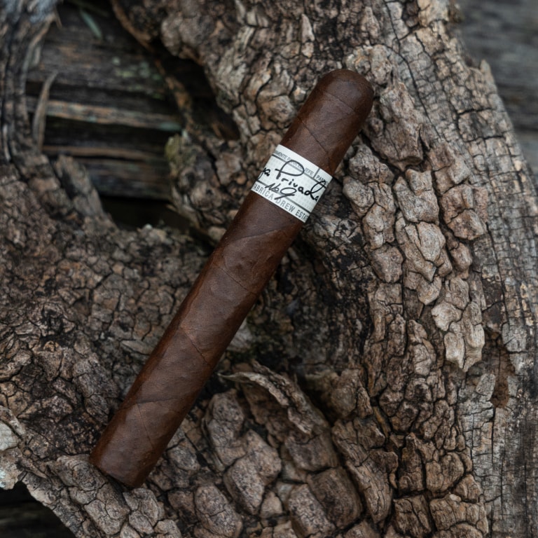 Liga Privada No.9 cigar rest atop a wooden log