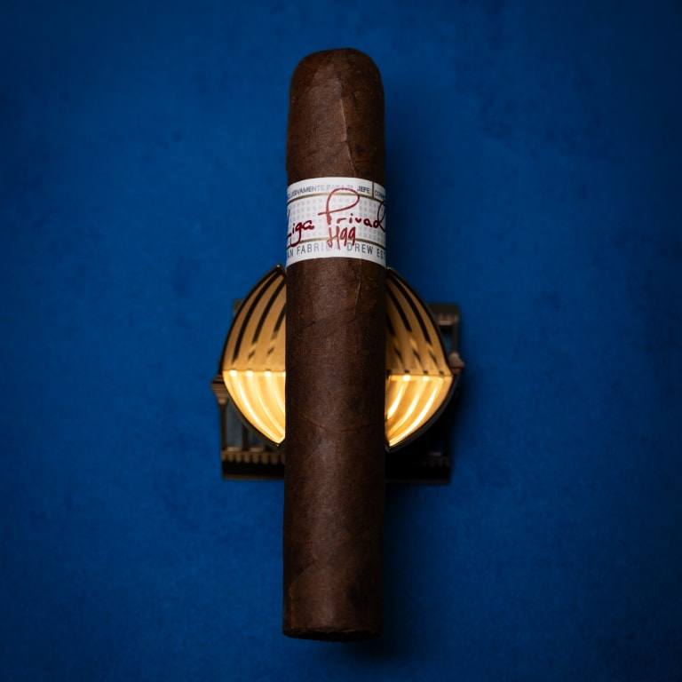 LIga Privada H99 cigar on a blue background