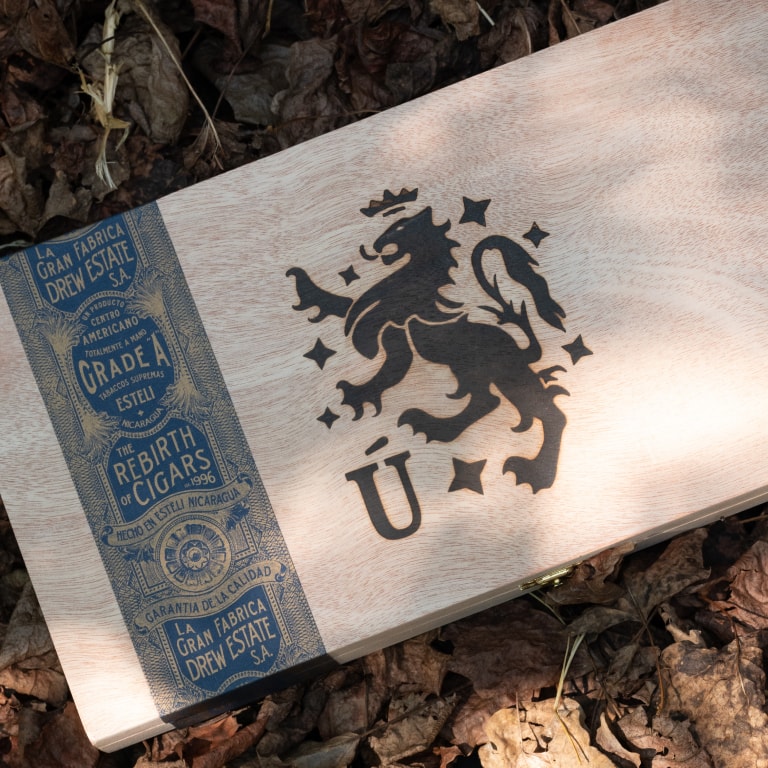 a box of Liga Privada cigars on a bed of leaves