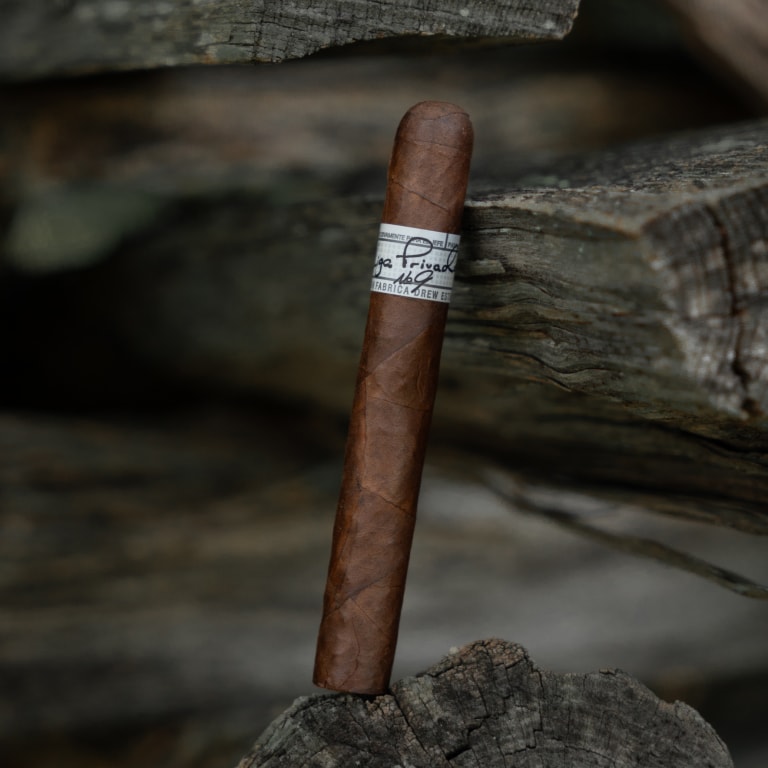 Liga Privada no.9 Cigar leaning against wood logs