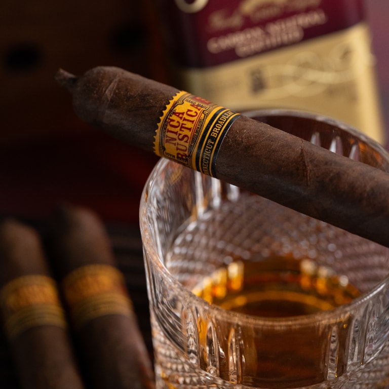 a Broadleaf Nica Rustica cigar over a liqueur glass
