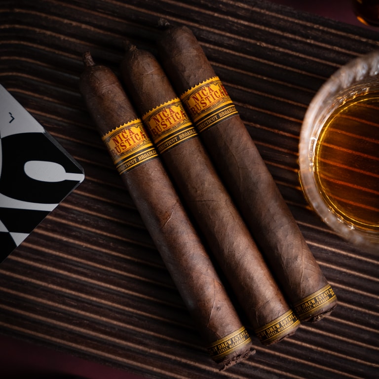 3 Nica Rustica Broadleaf cigars over a desktop