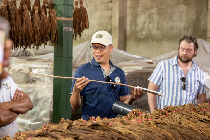 a group of people on a guided tour of the cigar factory