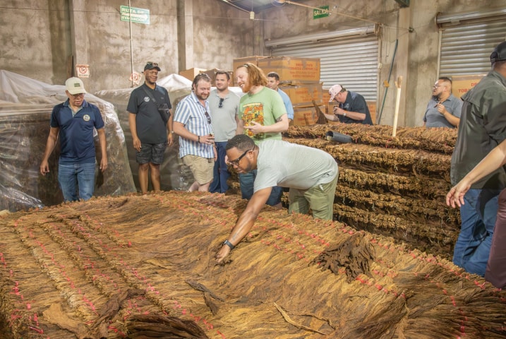 a group of people on a guided tour of the cigar factory