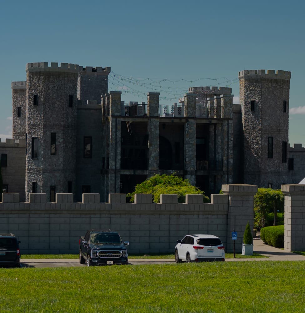 Sunset casts a warm glow over a castle wall, creating a picturesque backdrop for the family reunion experience