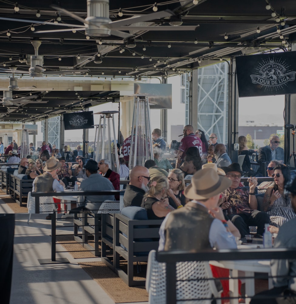 A group of people enjoying the Tour de Liga experience, seated at tables on a sunny patio