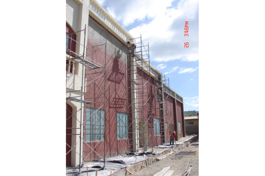A building under construction, featuring scaffolding on its side for support and access during renovations.