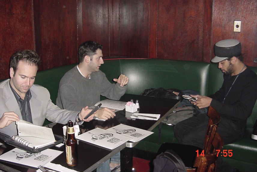 Three men collaborating at a table